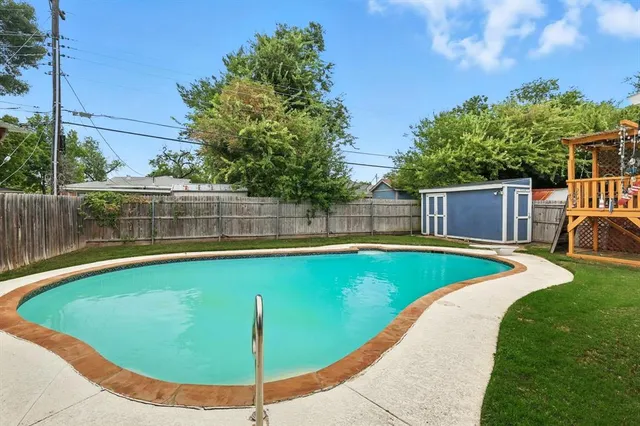 a view of a swimming pool with a yard
