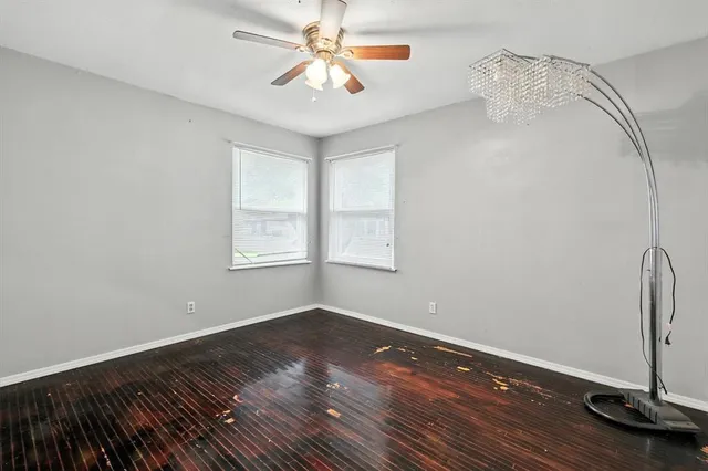 a view of a room with wooden floor and fan