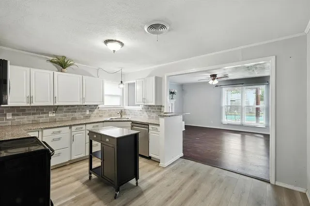 a kitchen with a sink stove and cabinets