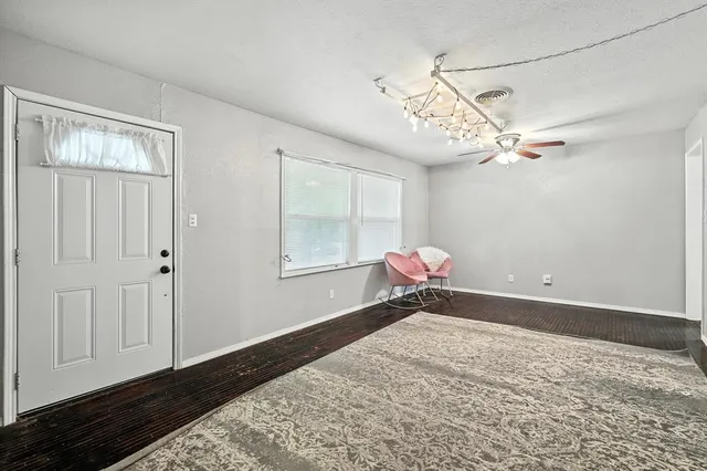 a bedroom with a bed and a chandelier fan