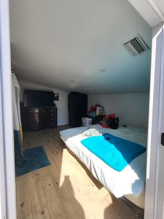 a bedroom with a bed and a flat tv screen