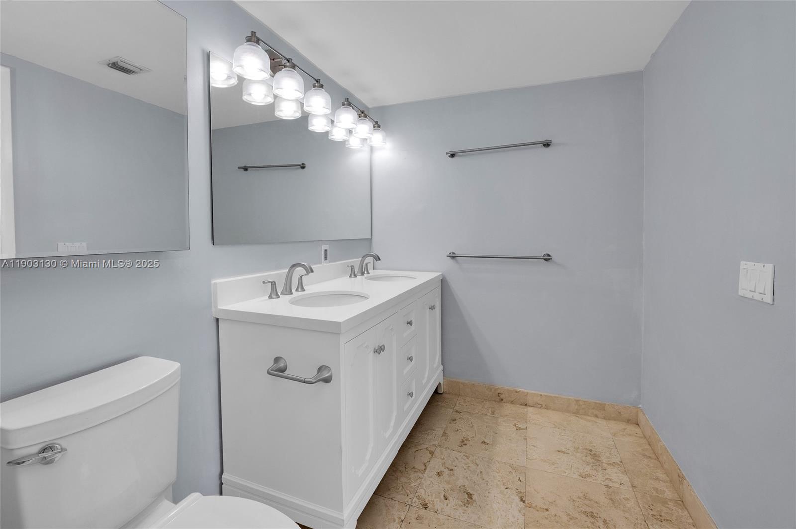 41 Southeast 5th Street, Unit 1515 Miami, FL 33131 - Photo 21 of 25 a bathroom with a sink and a mirror