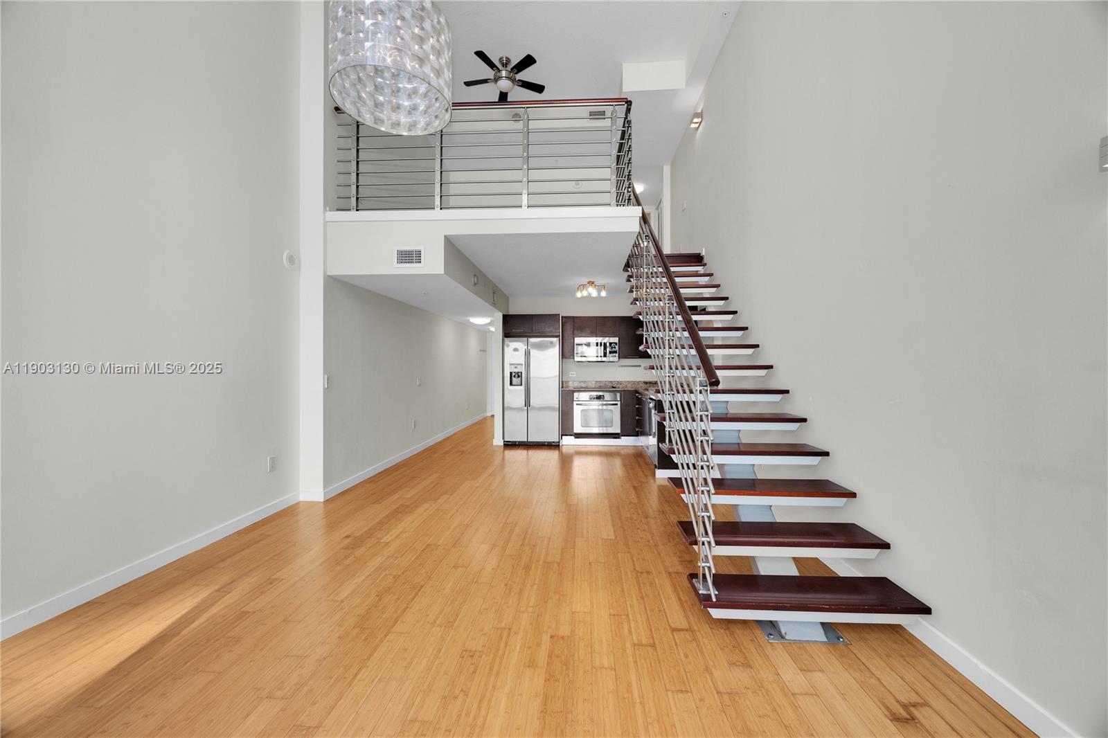 41 Southeast 5th Street, Unit 1515 Miami, FL 33131 - Photo 6 of 25 a view of a room with wooden floor and stairs