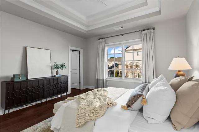 a bed sitting in a bedroom next to a window