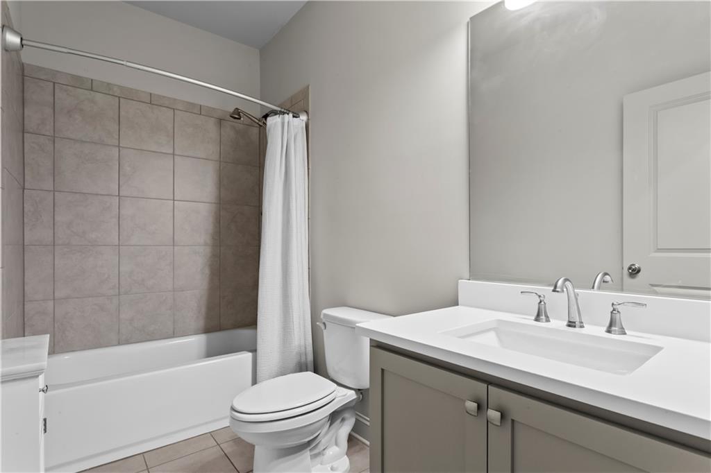 1892 Skyfall Circle Brookhaven, GA 30319 - Photo 22 of 24 a bathroom with a sink toilet and shower