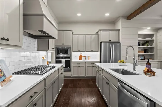 a kitchen with a sink stainless steel appliances and cabinets