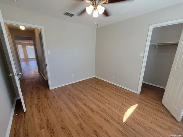 wooden floor in an empty room with a mirror