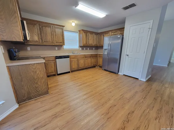 a kitchen with stainless steel appliances granite countertop a refrigerator sink and cabinets