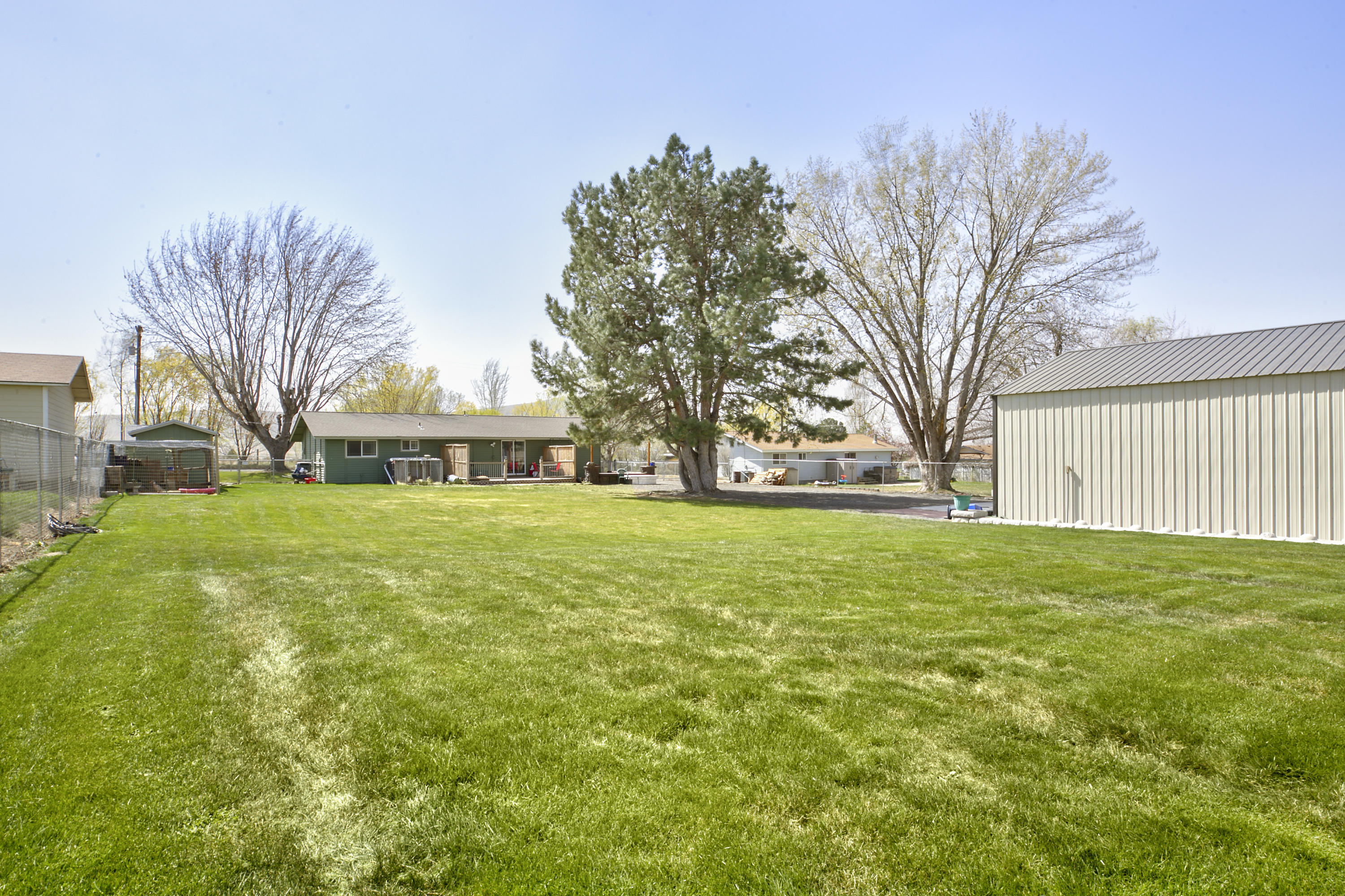 1111 Deeringhoff Road Moxee, WA 98936 - Photo 17 of 18 a yellow house with trees in front of it