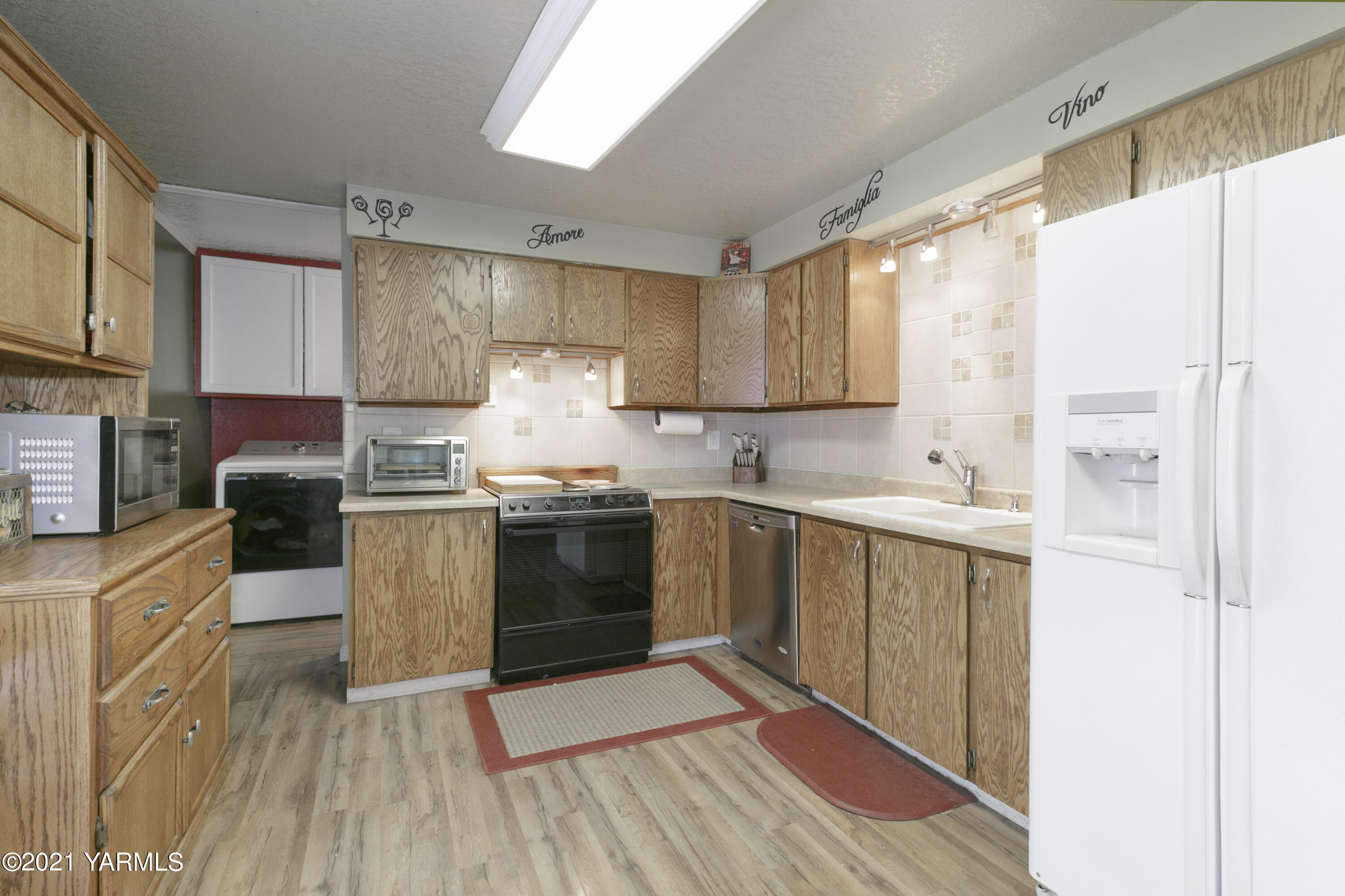 1111 Deeringhoff Road Moxee, WA 98936 - Photo 8 of 18 a kitchen with a sink a counter top space cabinets and stainless steel appliances