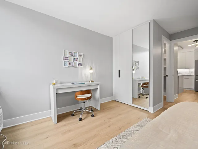 a view of a livingroom with a chair and front door