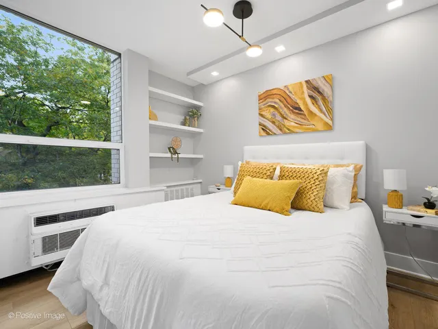 a bedroom with a bed and a large window