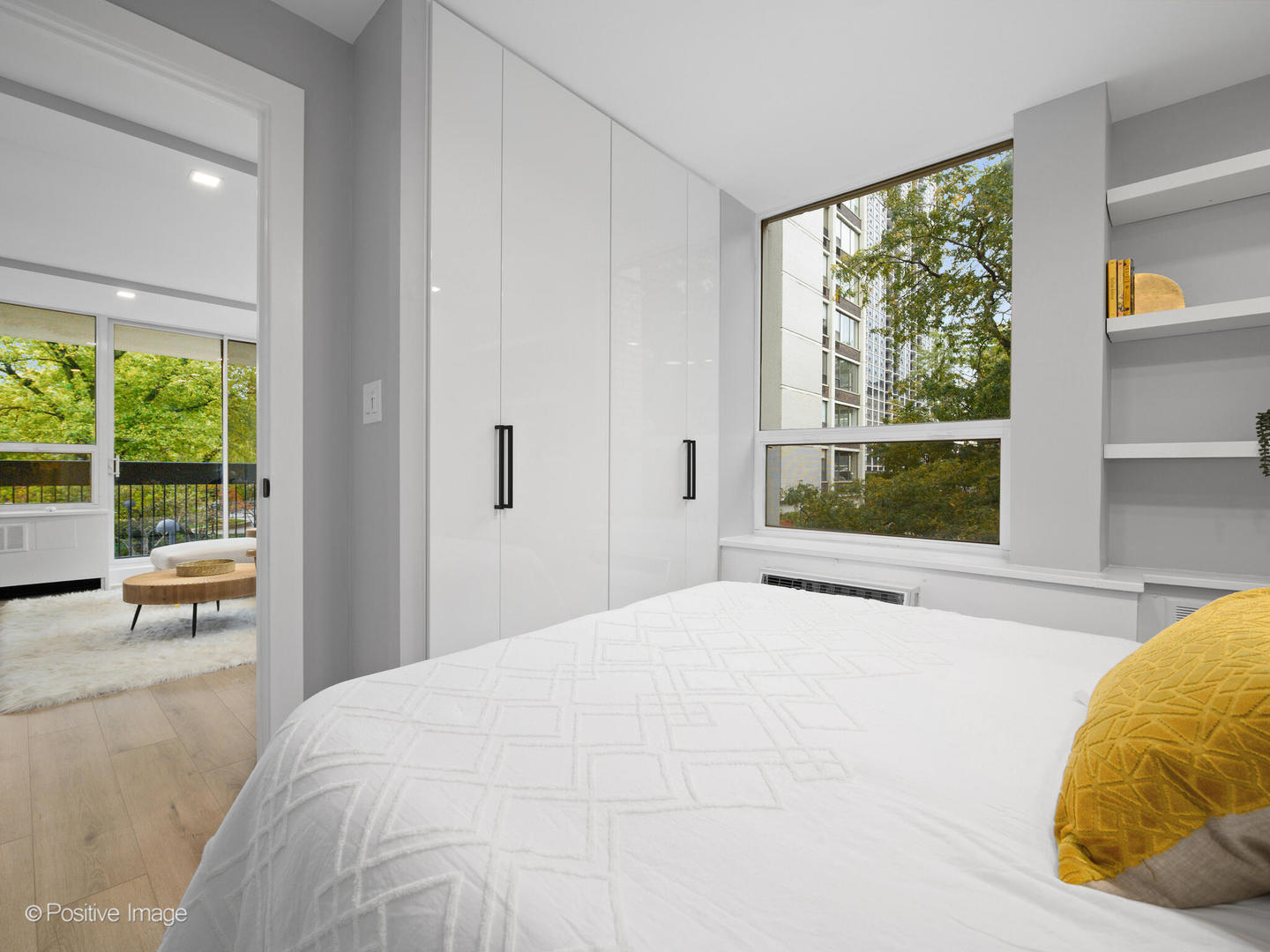 1455 North Sandburg Terrace, Unit 209B Chicago, IL 60610 - Photo 17 of 33 a bedroom with a bed and large windows