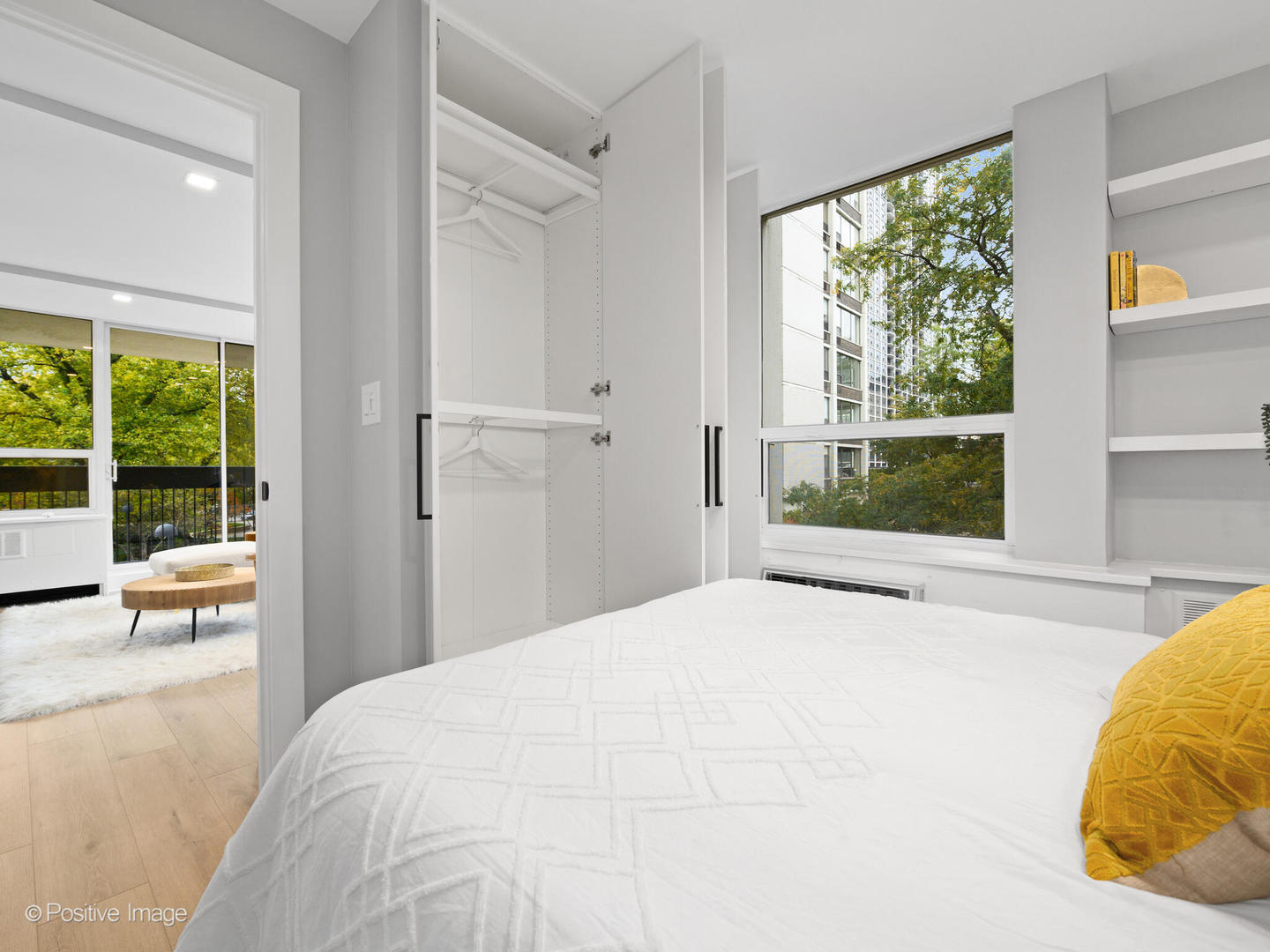 1455 North Sandburg Terrace, Unit 209B Chicago, IL 60610 - Photo 18 of 33 a bedroom with a bed and large windows