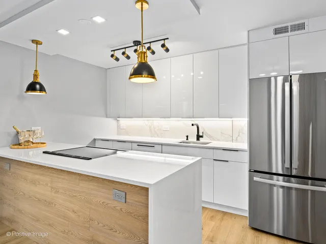 a kitchen with a sink a refrigerator and window