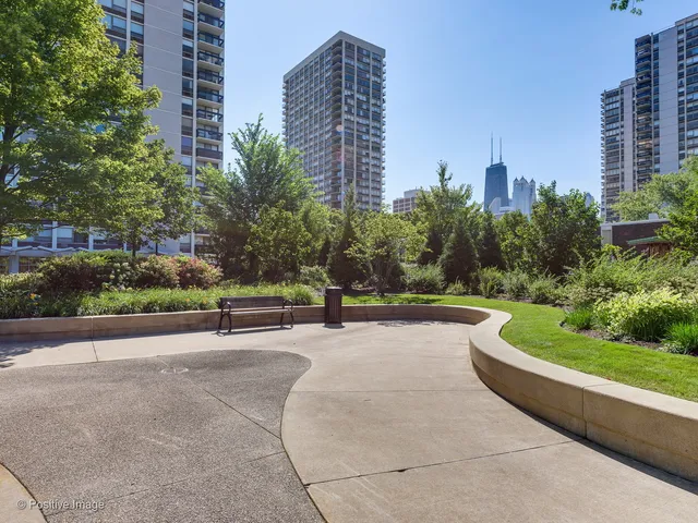 a road view with tall buildings in the background