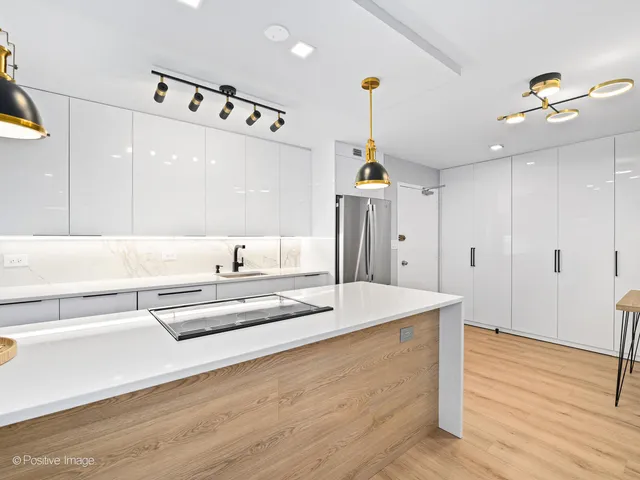 a spacious bathroom with a tub sink and mirror