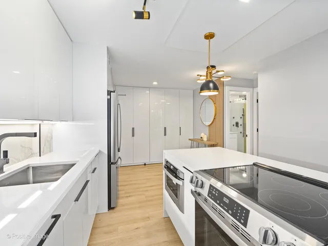 a large kitchen with a sink a stove and a refrigerator