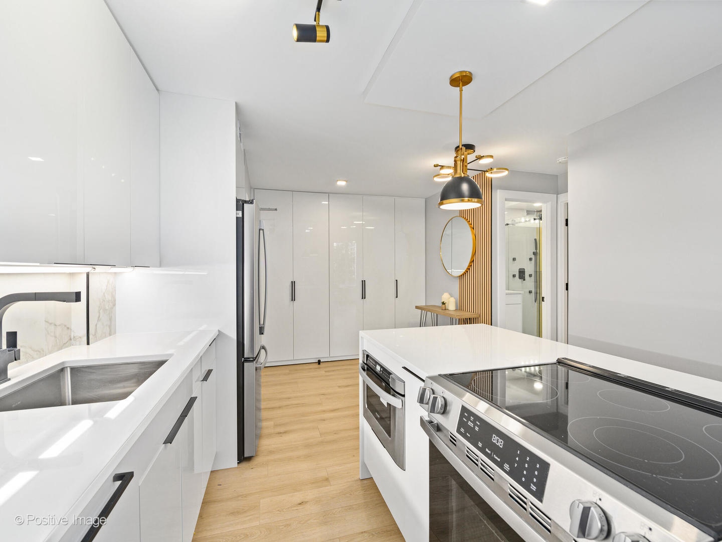 1455 North Sandburg Terrace, Unit 209B Chicago, IL 60610 - Photo 9 of 33 a large kitchen with a sink a stove and a refrigerator