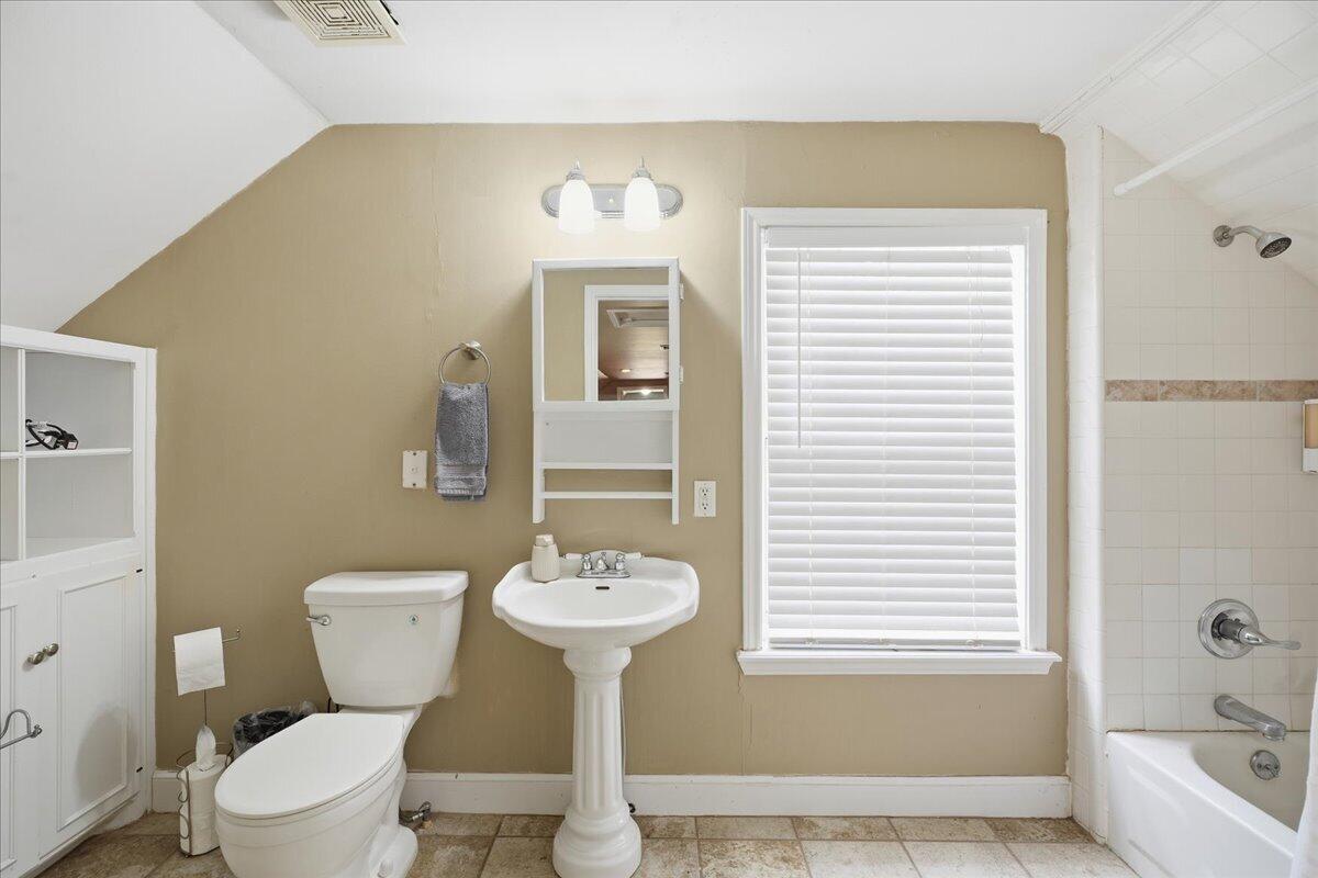 2702 20th Street Lubbock, TX 79410 - Photo 26 of 34 a bathroom with a sink toilet and shower