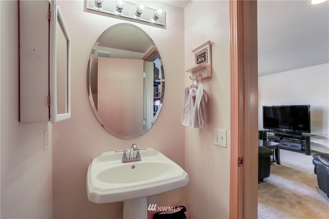 2310 Southeast 3rd Street Renton, WA 98056 - Photo 14 of 30 a bathroom with a sink a mirror and vanity