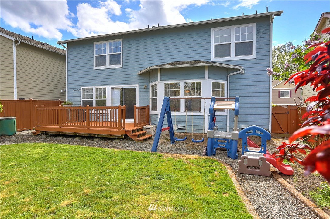 2310 Southeast 3rd Street Renton, WA 98056 - Photo 28 of 30 a backyard of a house with barbeque oven table and chairs