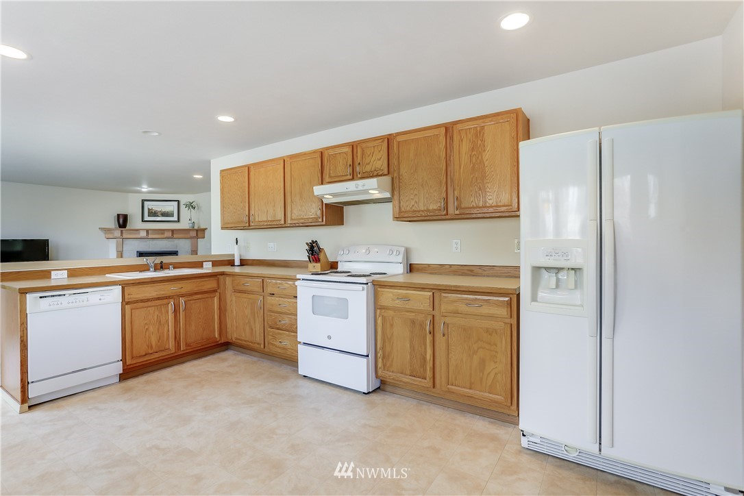2310 Southeast 3rd Street Renton, WA 98056 - Photo 9 of 30 a kitchen with white cabinets and white appliances
