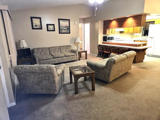 a living room with furniture and a large window