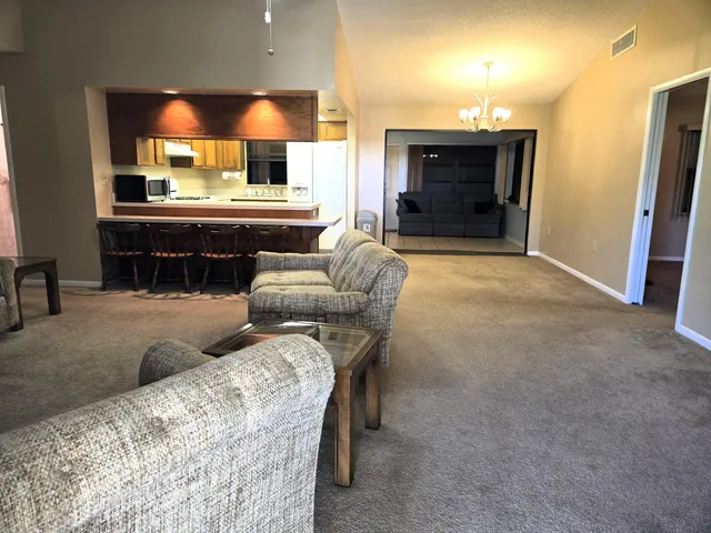 a living room with furniture and a large mirror