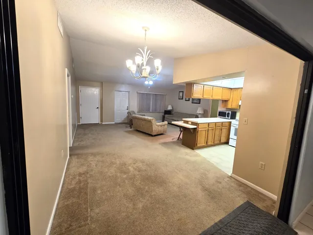 a living room with a sink and chandelier