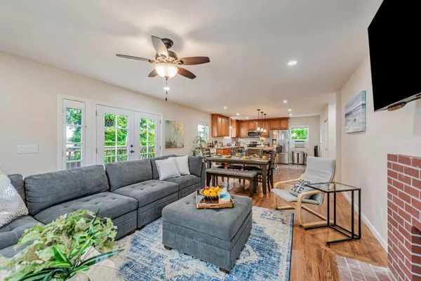 a living room with furniture a fireplace and a flat screen tv