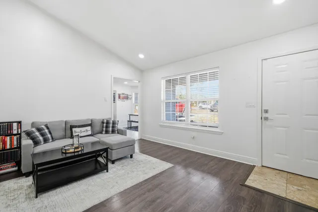 a living room with furniture and a potted plant