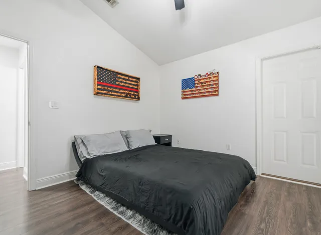 a bedroom with a bed and wooden floor
