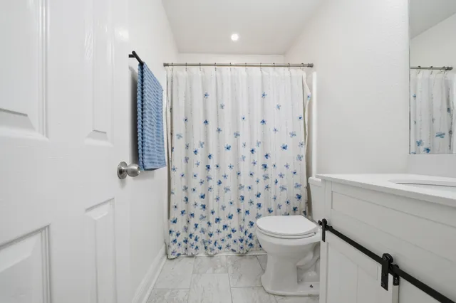 a bathroom with a toilet a sink and a shower