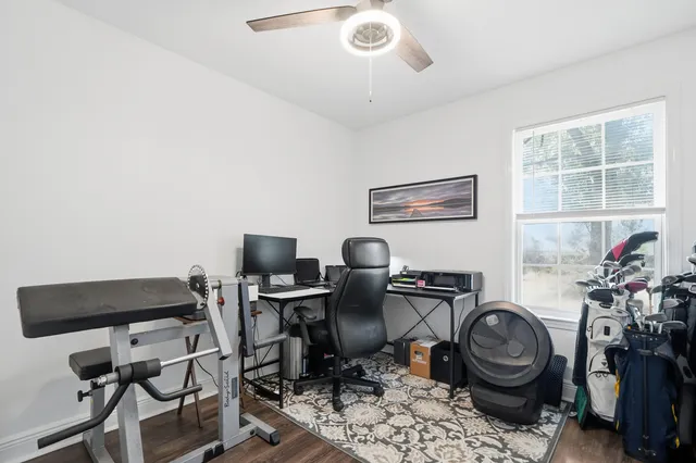 a view of a workspace with furniture and a window