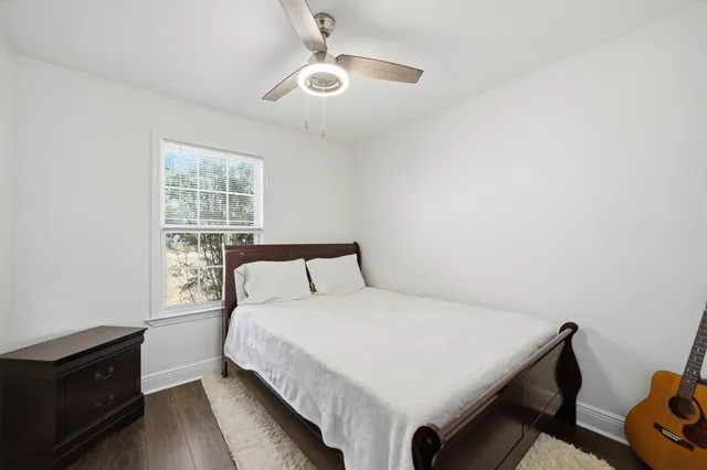 a large bed sitting in a bedroom next to a window