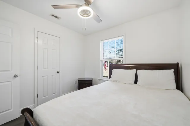 a bedroom with a bed and a painting on the wall