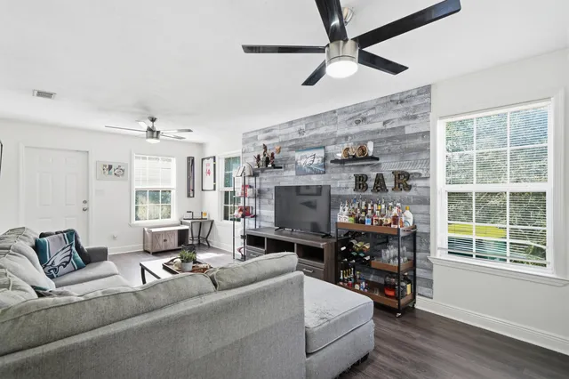 a living room with furniture and a flat screen tv