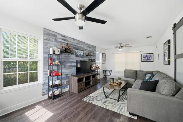 a living room with furniture and a flat screen tv
