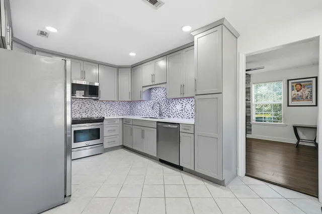 a kitchen with a sink cabinets and stainless steel appliances