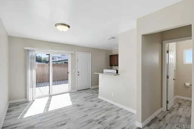 a view of a kitchen with a sink and a refrigerator