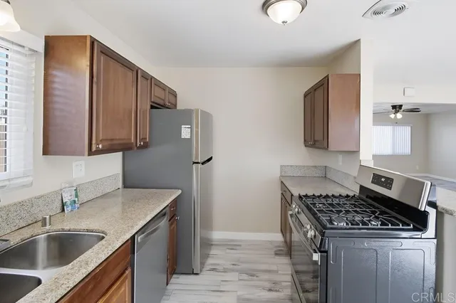 a kitchen that has a sink and a stove