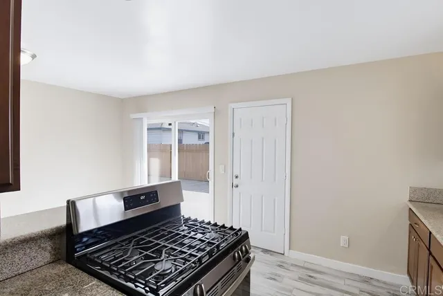 a room with wooden floor and a rug