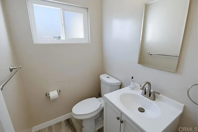 a bathroom with a sink mirror and toilet