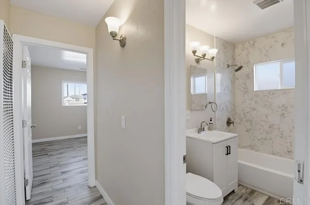 a bathroom with a sink toilet tub and shower