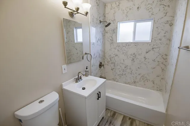 a bathroom with a bathtub sink and toilet