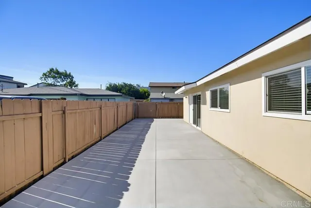 a view of a house with wooden fence