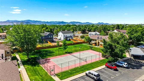 an aerial view of a houses with a garden and mountain view in back