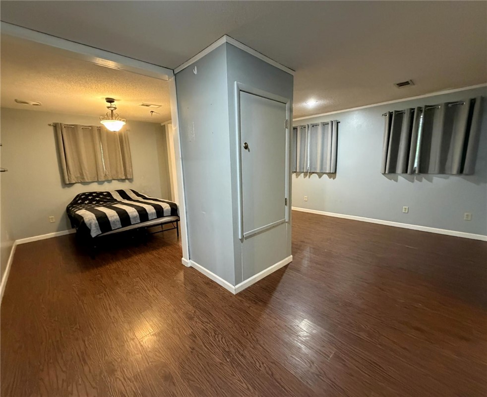 5108 Ridge Road Alma, AR 72921 - Photo 23 of 33 Rich wood-finish flooring extends throughout this interior space, complemented by light gray walls and white baseboards