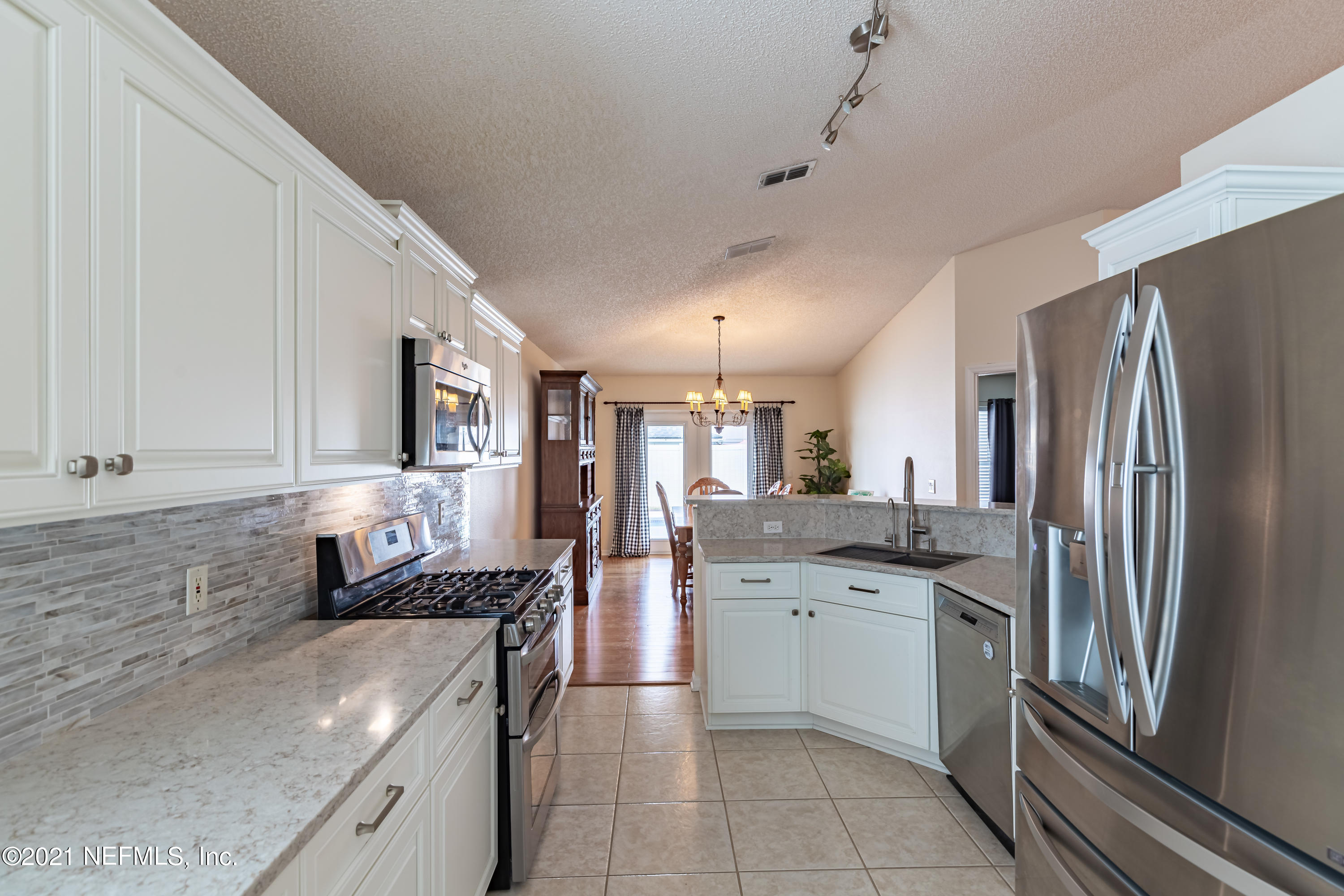 2602 Sunrise Ridge Lane Jacksonville, FL 32277 - Photo 13 of 35 a kitchen with a sink stove and refrigerator